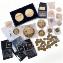 A collection of commemorative coins and medallions, subjects to include Winston Churchill, Queen