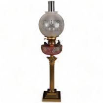 A Victorian Corinthian column oil lamp, with glass shade and font, H77cm The shade and funnel sit