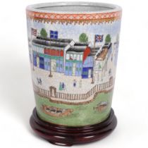 A Japanese crackle glaze pot, with design of buildings, people and flags, H22cm, on wooden stand