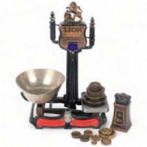 A Victorian "lion" cast-iron balance scale, by Herbert & Sons West Smithfield London, with various