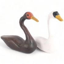 A carved and painted wood decoy study of a white swan, and another, tallest 34cm