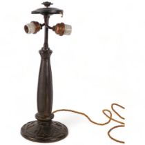 An early 20th century relief cast bronze table lamp in the manner of Tiffany, no factory marks,