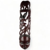 An African carved hardwood figural panel, L110cm