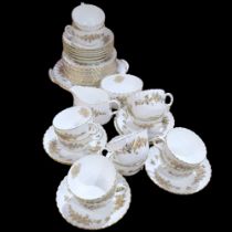 A Minton gold and white fluted tea service, comprising 12 cups, 12 saucers, 11 side plates, 2 cake