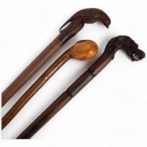 3 various turned wood walking canes, 1 with a carved dragon handle, another with a bird carved