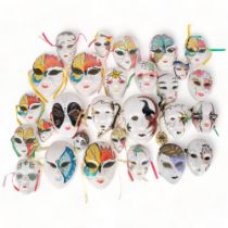 A collection of painted ceramic masks, various sizes