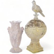 A verdigris metal garden ornament, depicting a bird on a globe, 49cm, and a metal vase with embossed