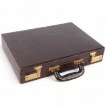 A Vintage amuet crocodile skin briefcase, with fitted interior, blotter, and brass locks, 41cm