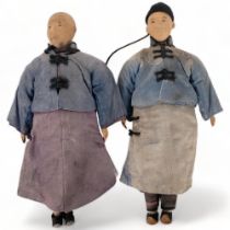 A pair of carved wood Oriental figures, in silk garments, L30cm