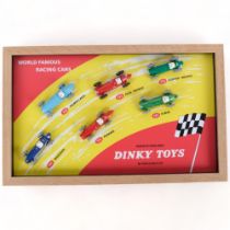 A Dinky Toys World Famous Racing Cars counter shop display, mounted in a wooden frame for wall