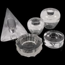 A group of glass candle holders, including a triangular crystal-cut candle holder, by Nybro of