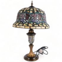 A Tiffany style table lamp, with coloured leadlight shade and centre column, on turned base,