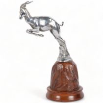 LEJEUNE - A chrome plate car mascot in the form of a leaping Gazelle, on a naturalistic carved wood