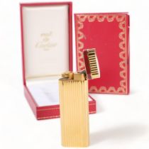 A Must De Cartier, Paris, gold plated briquet lighter, H7cm, serial no. 06098, complete with box