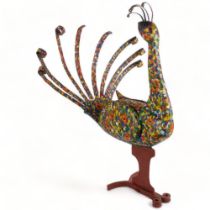 A highly decorative Folk Art study of a peacock, with a painted wood body and wrought-iron sprung