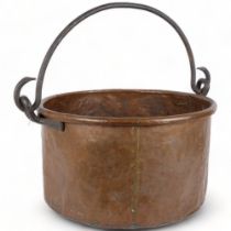 A large Antique copper cauldron, with cast-iron hooks and handle, H28cm, D49cm The pot appears to be