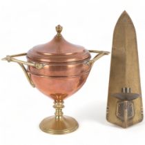 An Arts and Crafts style brass wall candle holder, L26cm, unmarked, and a brass copper tea urn,