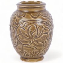 An Oriental stoneware glazed pot with incised floral decoration, H15cm