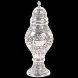 An early 20th century Scandinavian silver baluster pepperette, relief embossed foliate decoration,