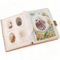 A Victorian velvet covered photograph album, containing a collection of carte de visite and