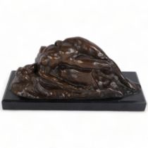 A contemporary bronze study of a reclining nude on a rock, on black marble base, W33cm