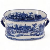 A large reproduction blue and white 2-handled foot bath