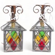 A pair of coloured leadlight lanterns, with wrought-iron mounts, with electric fittings, overall