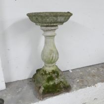 A two-section weathered concrete birdbath. Height 79cm.