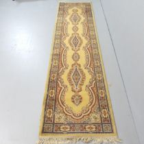 A mustard ground Bokhara design runner. 272x69cm Used condition. Some fading and stains.