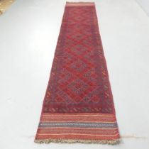 A red-ground Meshwani runner. 260x55cm