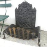 A cast iron fire back, 49x70cm, and a fire grate. (2)