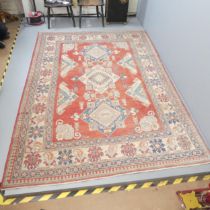 A red-ground Serapi carpet. 296x210cm Faded, but otherwise in good condition.