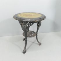 A painted circular topped garden table on cast iron base. 59x71cm Split to top. Has some amateur
