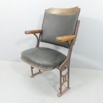 A vintage folding leather upholstered cinema seat on cast iron frame. Overall 59x93x42cm, seat