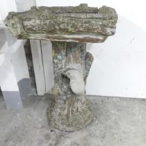A weathered concrete two-section bird bath. 36x60cm.