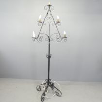 A painted wrought metal gothic candelabra converted to electric. Height 184cm.