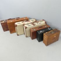 Seven various suitcases, including two with MOD arrow marks dated 1982. Largest 72x20x41cm.