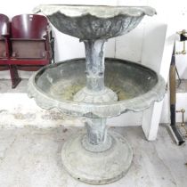 A large and impressive two-tier patinated bronze water fountain, with ornate floral and foliate