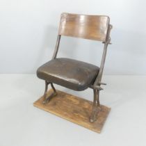 A vintage folding leather upholstered cinema seat mounted on wooden plate. Overall 74x83x44cm,