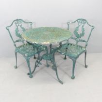 A painted cast aluminium circular garden table, 69x69cm, and two matching chairs.
