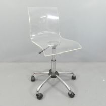 A contemporary acrylic ergonomic swivel desk chair on chrome base, with rise and fall mechanism.