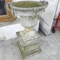 A large and impressive five section weathered concrete continental style garden urn on pedestal