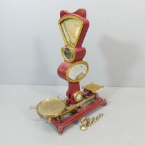 A large set of early to mid century industrial grocer's shop scales, of enamel gilt metal