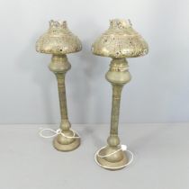 A pair of Morrocan style brass floor lamps, with pierced and repousse decoration. Height overall