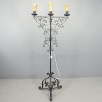 A painted wrought iron gothic candelabra converted to electric. Height 164cm.