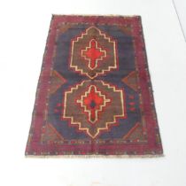 A red-ground Baluchi rug. 135x90cm.