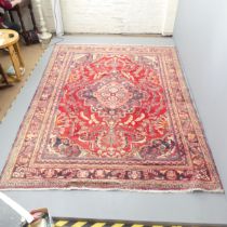 A red-ground Iranian Lilihan carpet. 300x230cm. Generally good condition, some fading in places.