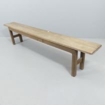 A rustic oak bench. 205x44x26cm Screw repairs to both legs. Some worm damage. Marks, scratches and