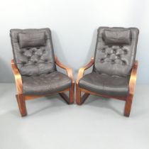 A pair of vintage Danish design leather upholstered armchairs with bentwood frames.