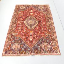 A red-ground Quashqai carpet. 218x145cm. Good condition.